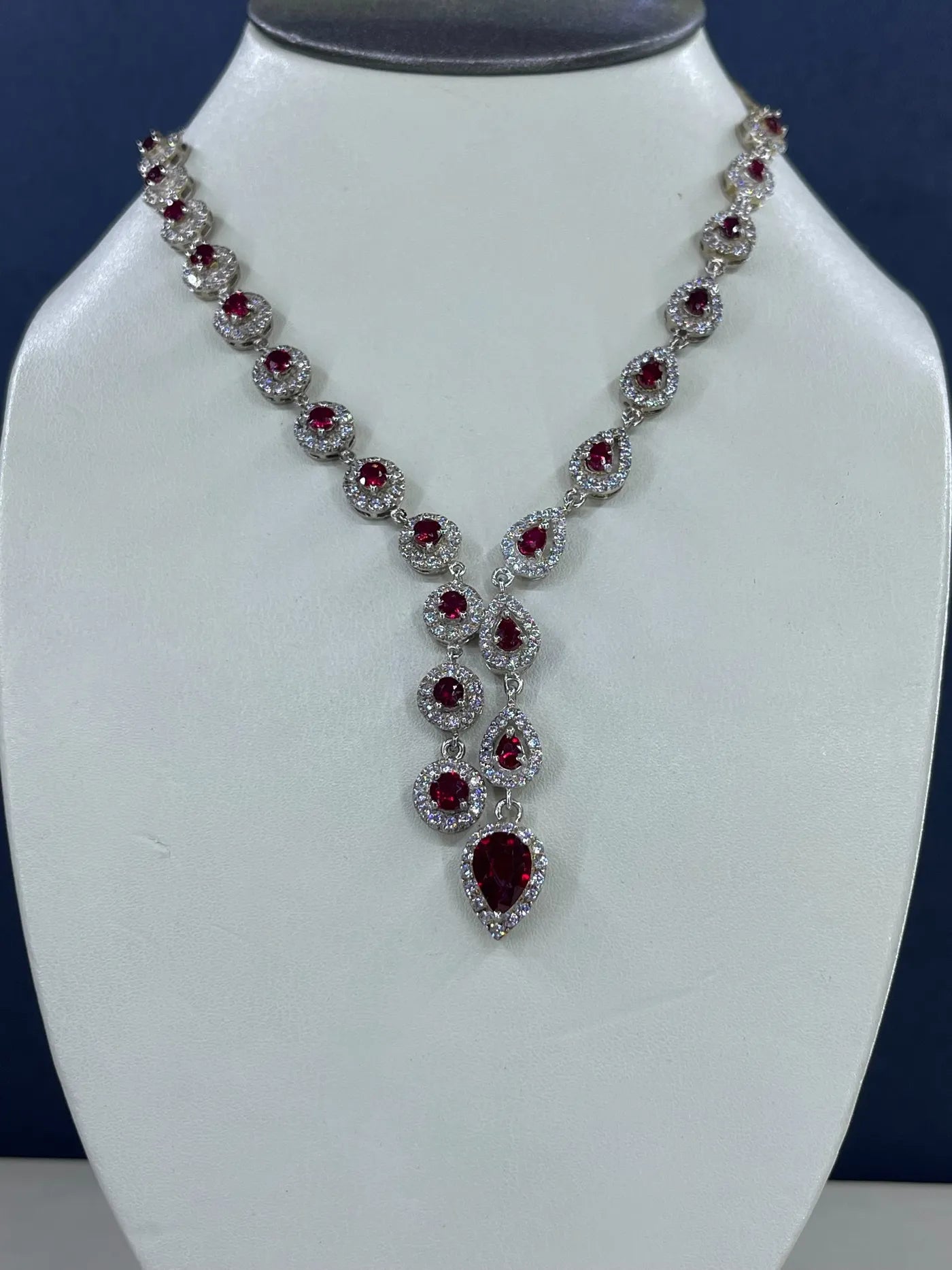 Ruby necklace on a white display bust